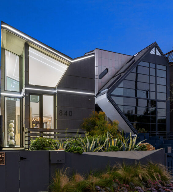 A spacious house with numerous windows and lush greenery in Venice Beach